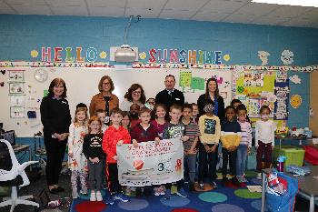 A happy group of students at Wixom Elementary celebrate the grant their teacher received. 